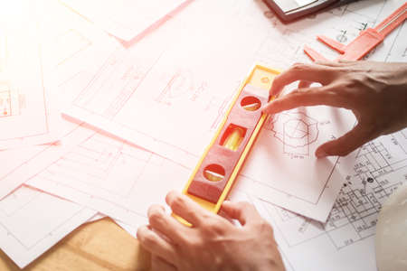 Concept architects, equipment architects On the desk with a blueprint in the office, Vintage, Sunset ligth.Selective Focusの写真素材