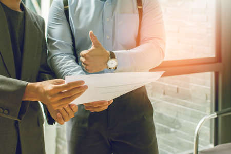 Asia Businessman together create a mutually beneficial business relationship. Economic graph on the tableの写真素材