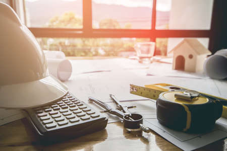 Concept architects, equipment architects On the desk with a blueprint in the office, Vintage, Sunset...