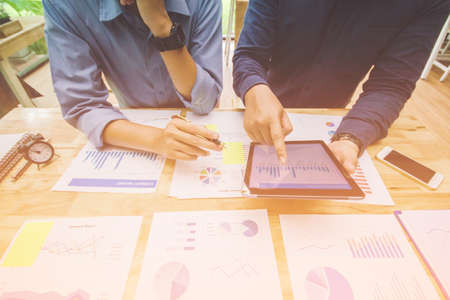 Start up business. people team work meeting point to discuss the graph up and down of economy and...
