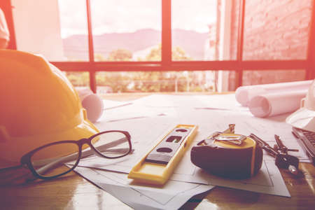 Concept architects, equipment architects On the desk with a blueprint in the office, Vintage, Sunset ligth.Selective Focusの写真素材