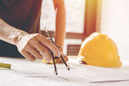 Concept architects, equipment architects On the desk with a blueprint in the office, Vintage, Sunset ligth.Selective Focusの写真素材