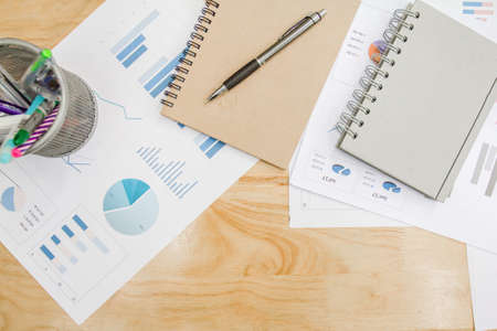 Top view Office desk with notebook,supplies and hot coffee,graph paper.copy space for textの写真素材