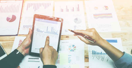 Start up business. people team work meeting point to discuss the graph up and down of economy and...
