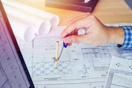 Concept architects, Two asian engineer pointing equipment architects On the desk with a blueprint in the office, Vintage, Sunset light.Selective Focusの写真素材