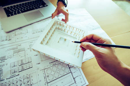 Top view,Concept architects,engineer holding pen pointing equipment architects On the desk with a blueprint in the officeの写真素材