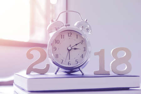 2018 Happy New Year with clock , book on wood isolated white background,Vintage tone,Copy space for...