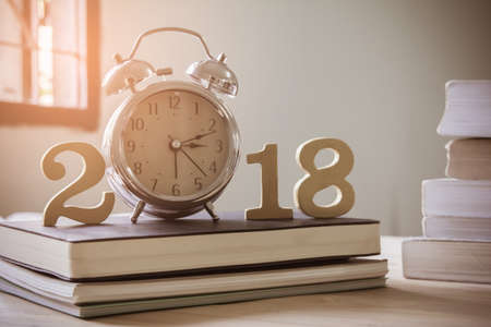 2018 Happy New Year with clock , book on wood isolated white background,Vintage tone,Copy space for...