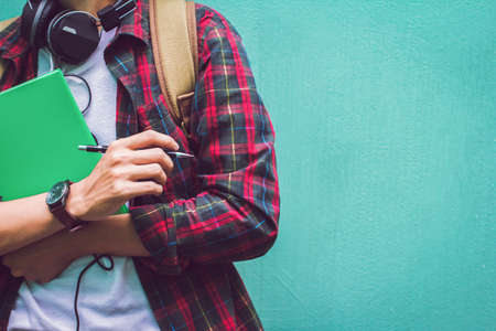 Education Concept. Man in  Scottish shirt.Holding green notebook  Waiting studying,learning ,Tutor...