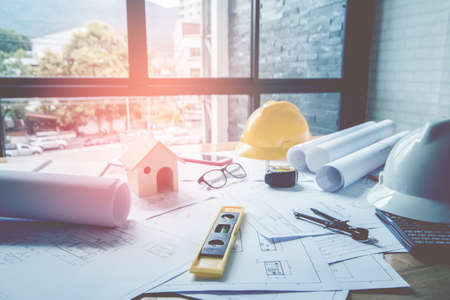 Concept architects, equipment architects On the desk with a blueprint in the office, Vintage, Sunset...