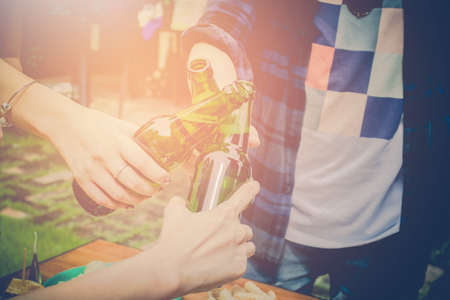 Top view,Close up hands,Two asian woman and one men.Drinking beer,are smile.Group celebration party eating happy, concept,Vintage toneの写真素材
