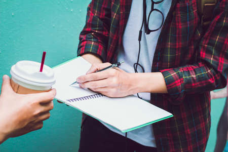 Student taking down notesの写真素材