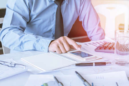 Asian young businessman holding mobile phone chat Meetings the commercial processes involved in...