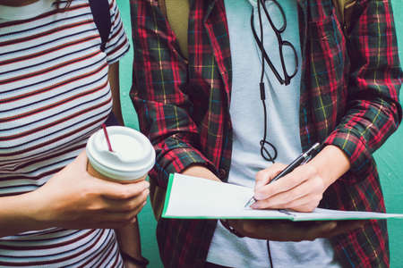 Education concept. Two Asian women one student or roommate with friend helps analyzing workbook...