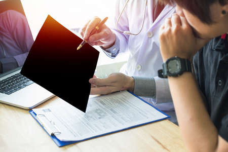 Doctor looking film x-ray image,Breast Cancer Female patient  and Introducing, Taking Care of Yourselfの写真素材