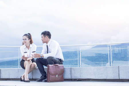 Couple business people sitting with talking.outdoorの写真素材