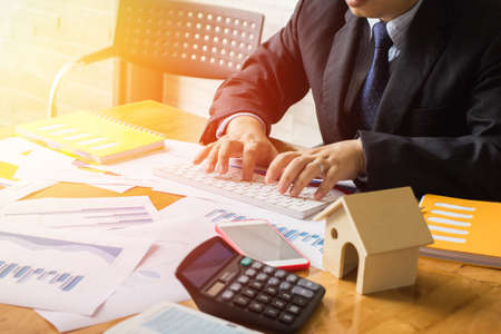 Start up business.  working  to discuss the graph up and down of economy and work on keyboard laptop.Selective Focusの写真素材