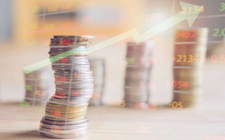 Financial accounts and coins on the table with sunset focus focus.の写真素材