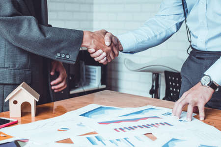 Group asia businessman together create a mutually beneficial business relationship. Economic graph on the tableの写真素材