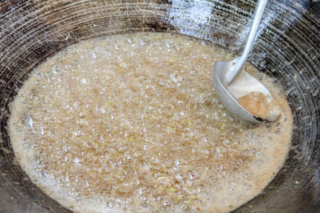 Fried garlic on pan in kitchen cooking food.の写真素材