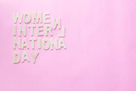 Text Wooden letter design with date of International Women's Day on pink background.の写真素材