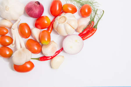 organic fresh colorful vegetables with potatoes, tomatoes,coriander,chilli, onion. Minimalism on white background.Copy space for your text.の写真素材