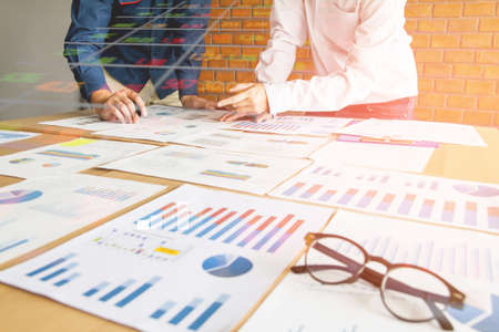 Start up business. people team work meeting point to discuss the graph up and down of economy and...