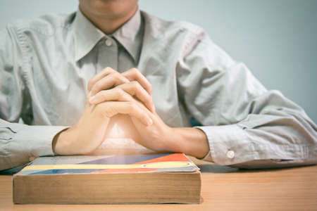 close up, the pastor laid hands on the black book of the Bible, Buddhist, Catholic, Christian, prayer, and pray for blessings from God, all people are safe from harm.Soft focus,Selective focusの写真素材