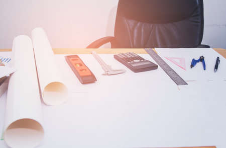 Concept architects, equipment architects On the desk with a blueprint in the office, Vintage, Sunset ligth.Selective Focusの写真素材