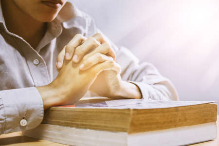 close up, the pastor laid hands on the black book of the Bible, Buddhist, Catholic, Christian,...