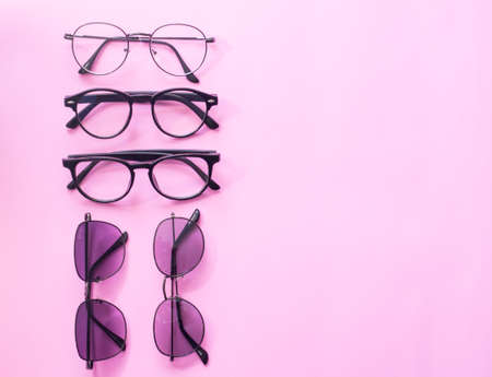 Set glasses or sunglasses object fashion minimal modern style, accessory travel on Pink pastel color background. Top viewの写真素材