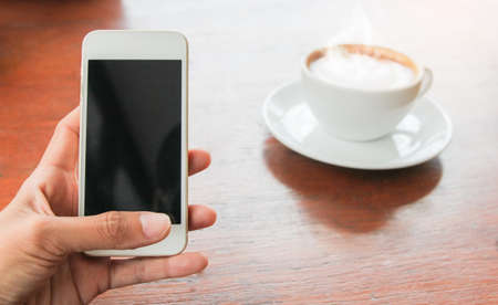 Close up of woman hands holding touching mobile phone with blank copy space for your text message in...