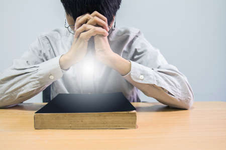 close up, the pastor laid hands on the black book of the Bible, Buddhist, Catholic, Christian, prayer, and pray for blessings from God, all people are safe from harm.の写真素材