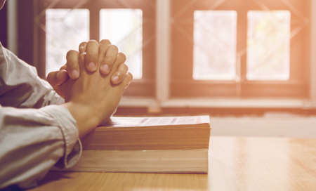 close up, the pastor laid hands on the black book of the Bible, Buddhist, Catholic, Christian, prayer, and pray for blessings from God, all people are safe from harm.の写真素材