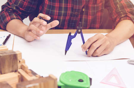 architectural projects office working with blueprints.Selective focus.Vintage tone with sunset background.の写真素材