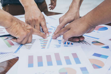 Start up business. people team work meeting point to discuss the graph up and down of economy and...
