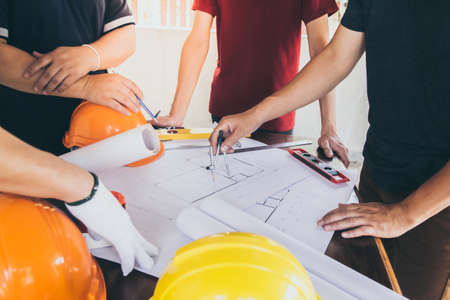 Construction workers and chiefs or architects are meeting on the interior design of the housing...