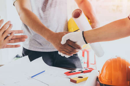 Asian engineer handshaking for teamwork in Interiors design and construction plan. Architect conceptの写真素材