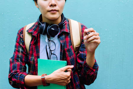 Education Concept. Man in Scottish shirt.Holding green notebook Waiting studying,learning ,Tutor...