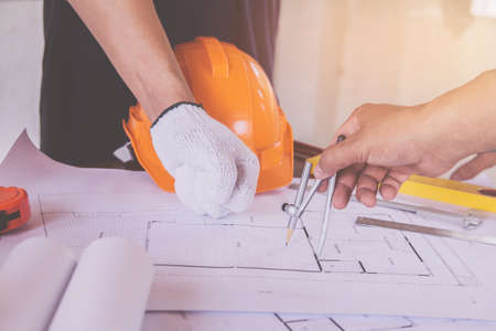 group asian engineer meeting On the desk with a blueprint in the office, Vintage, Sunset light.Selective Focusの写真素材