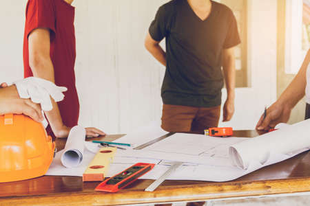 Concept architects, equipment architects On the desk with a blueprint in the office, Vintage, Sunset...