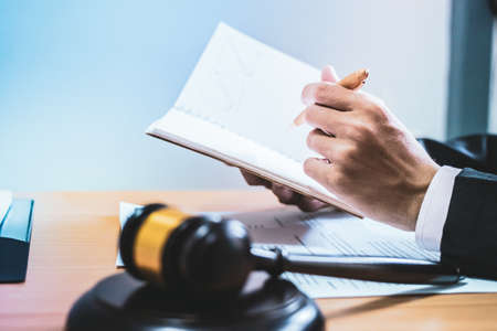 Hammer.Businessman sitting office Signing Signature contract papers on wood table. law of advisor...