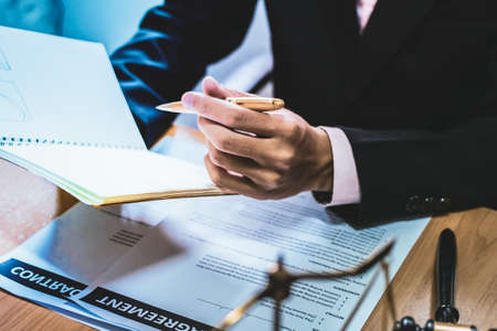 businessman or lawyers sitting office signing contract papers on wood table. Law of advisor Concepts...