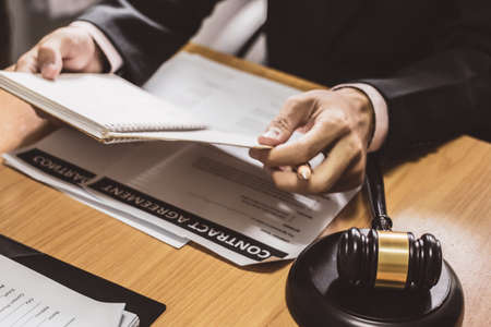 businessman or lawyers sitting office signing contract papers on wood table. Law of advisor Concepts...