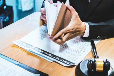 businessman or lawyers sitting office signing contract papers on wood table. Law of advisor Concepts and vintage, Sunset light.Selective Focusの写真素材