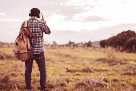 Blur. Teens are listening to music at close range with a light sunset background.の写真素材