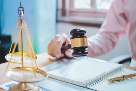 Holding Hammer law.Business man working on table. Lawyer Concepts .Selective Focus