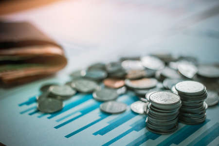 Silver coins on desk with light sunset