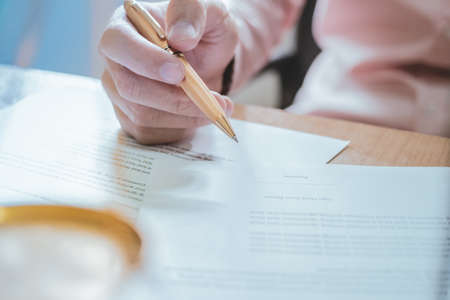 businessman or lawyers sitting office signing contract papers on wood table.
