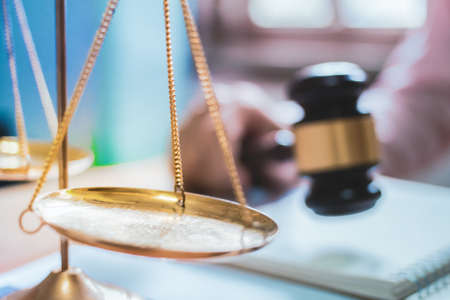 Holding Hammer law.Business man working on table. Lawyer Concepts .Selective Focusの写真素材